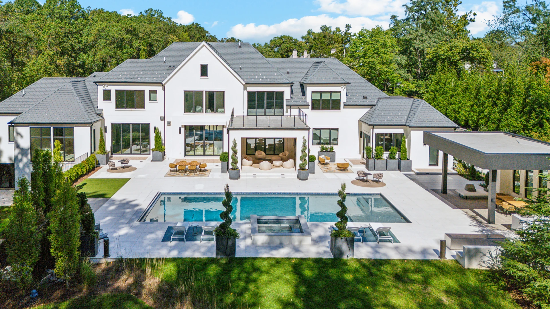 Clean, crisp, sleek - a contemporary hardscape with accentuating landscape and horticulture elements to shape the outdoor experience of this modern home.